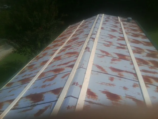Rusted metal roof panels with new wood purlins before replacement — Storm Damage Roof Repair in New City by Roofing Brothers